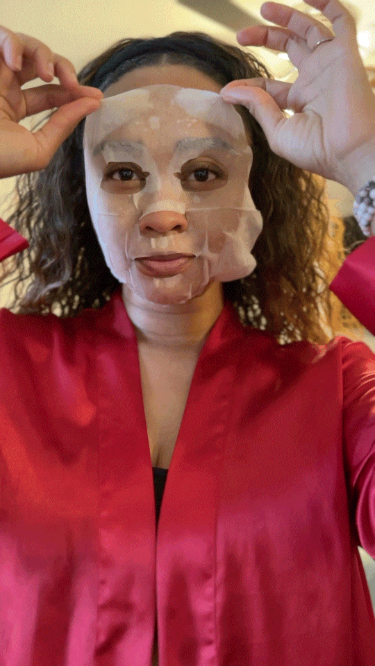 Black Woman taking off snail mask