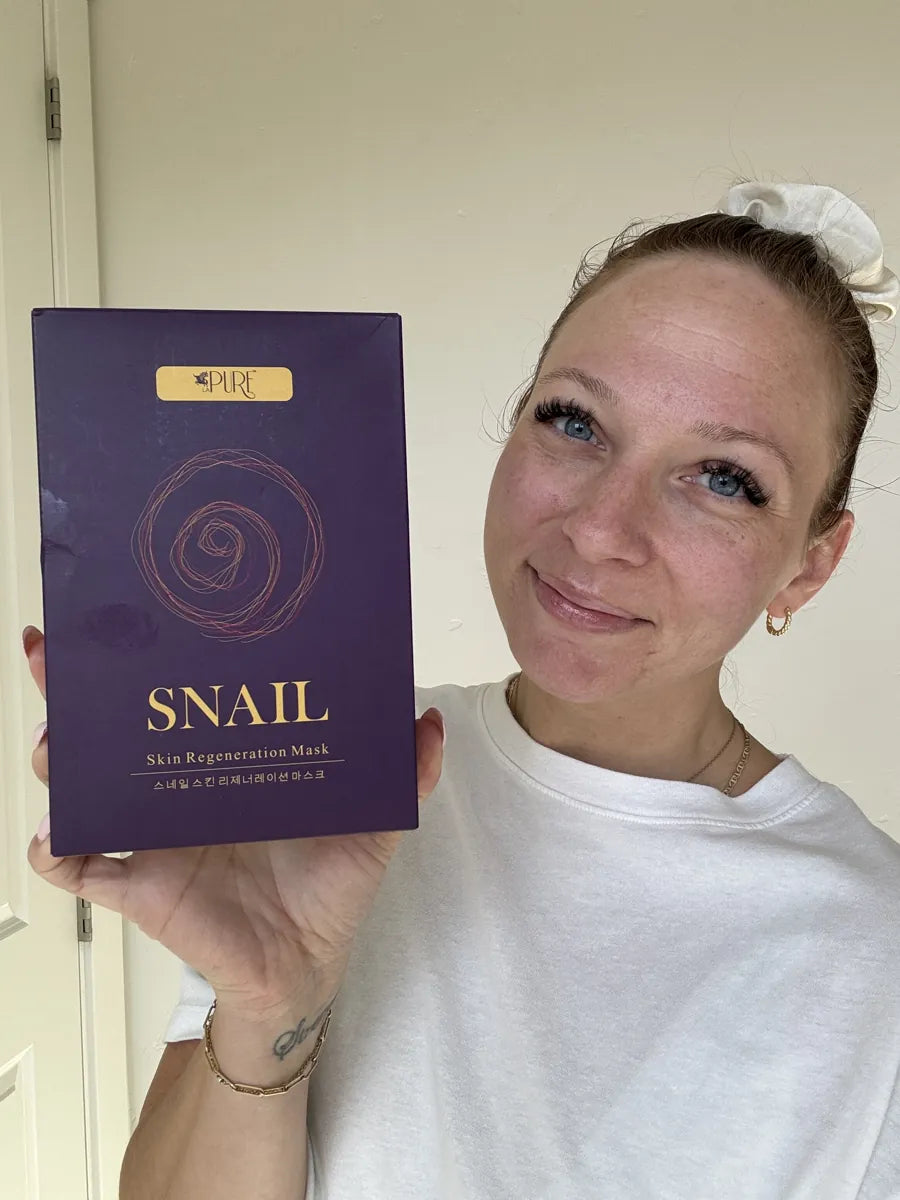 Woman holding box of snail masks