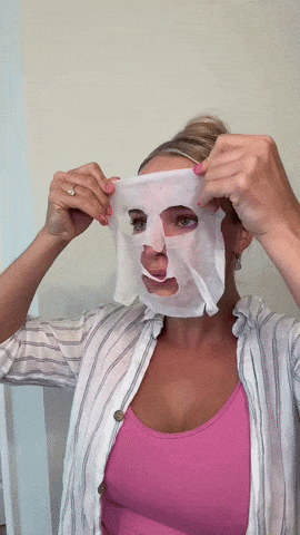 Woman putting on snail mask