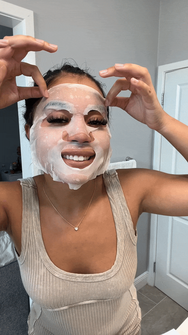 Woman removing snail mask in bathroom