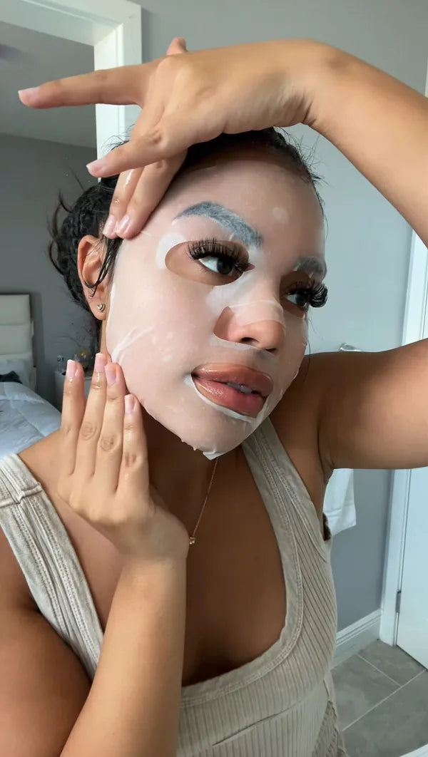 Woman with snail mask on in bathroom