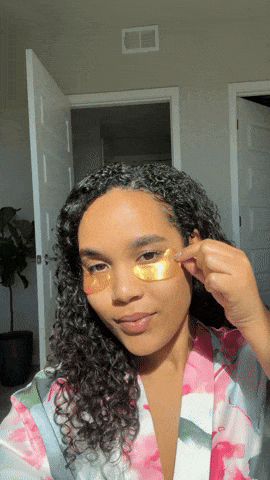 Woman removing eye mask